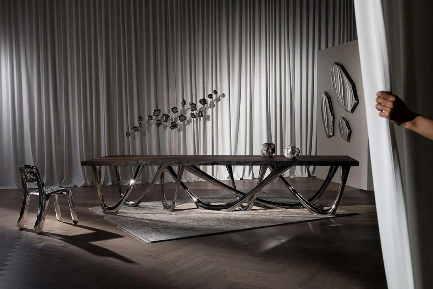 CUSTOMIZED STEEL TABLE BY ZIETA STUDIO, chippensteel chair and mirrors in an interior setting